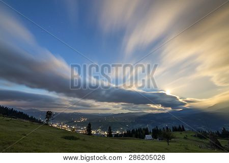 Summer Night Mountain Panorama. Green Grassy Mountain Clearing, Spruce Trees On Blue Evening Sky Cop