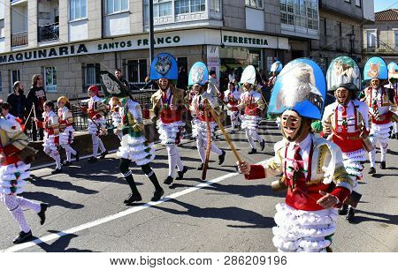 Verin, Spain, 24 Feb 2019. Famous Carnival And Street Parade With Cigarrons Costumes. Ourense Provin