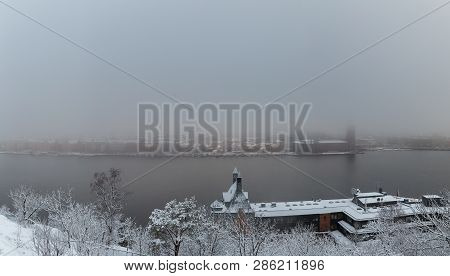 Foggy City View Over The River Riddarfjarden In Stockholm Sweden On A Winter Day With Snow Melting