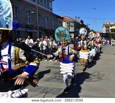 Verin, Spain, 24 Feb 2019. Famous Carnival And Street Parade With Cigarrons Costumes. Ourense Provin
