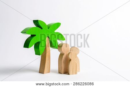 Wooden Palm Tree And Family. Family Holidays With Children. Tours And Cruises To Warm Countries. The