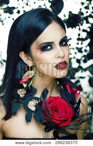 Pretty Brunette Woman With Rose Jewelry, Black And Red, Bright Make Up Kike A Vampire Closeup Red Li