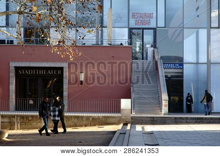 Aschaffenburg, Germany - November 17: Pedestrians And Childrens In Front Of The Modern Glass Facade 