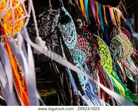 Dream Catcher Made Of Handmade Colors Hanging In The Sun And Moved By The Wind. Typical Handicrafts 