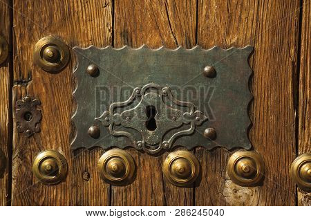 Bronze Studs And Wrought Iron Keyhole In An Old Door At Caceres