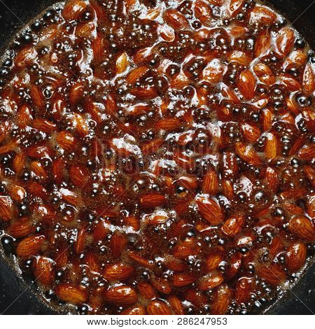 roasted almonds with cinnamon sugar cooking process, top view close-up