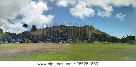 Kapiolani Park At During Day With Diamond Head And Clouds In The Distance On Oahu, Hawaii.