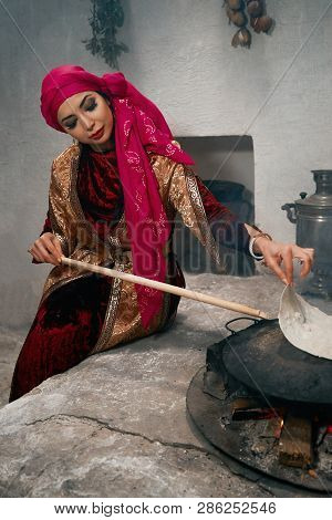 Woman Preparing Or Making Borek Or Bread Dough On Fire