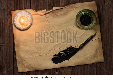 Parchment Paper With Quil Pen And Ink Lit By Candle