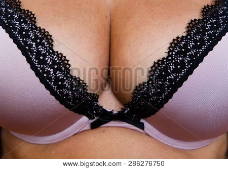 Bra And Beautiful Elastic Natural Female Breasts Close-up. Lingerie.
