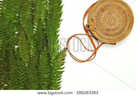Fashionable Handmade Natural Organic Rattan Bag And Green Fern Leaves, Pink Flower Isolated On White
