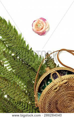 Fashionable Handmade Natural Organic Rattan Bag And Green Fern Leaves, Pink Flower Isolated On White
