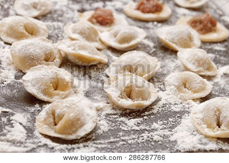 Raw Yellow Dumplings, Flouted Lie On Wooden Brown Board