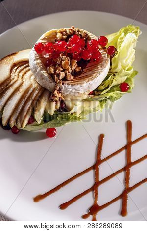 Grilled Camambert Cheese With Walnuts And Grilled Pear On White Plate, Restaurant Meal