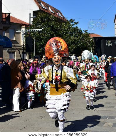 Verin, Spain, 24 Feb 2019. Famous Carnival And Street Parade With Cigarrons Costumes. Ourense Provin