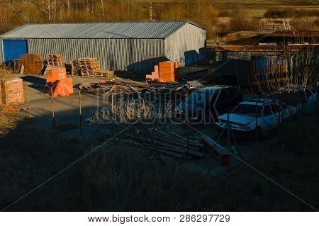Prunerov, Czech Republic - February 15, 2019: Industiral Areal Mit Old Cars During Sunset