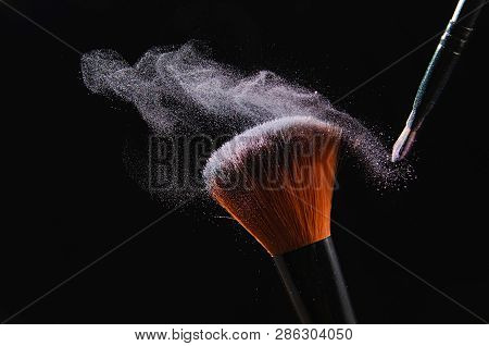 Cosmetic Brush On Black Background With Powder Or Shadows