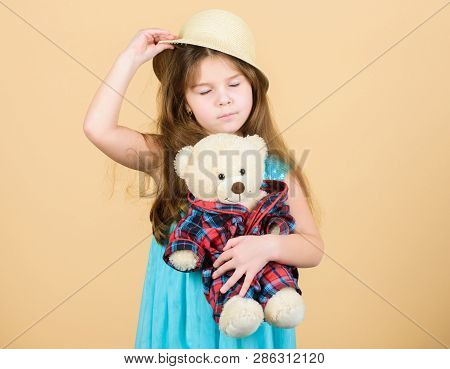 Small Girl Straw Hat Hold Teddy Bear Plush Toy. In Love With Cute Teddy Bear. Happy Childhood. Tende