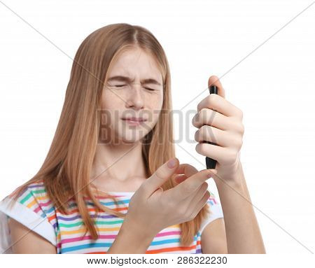 Teen Girl Using Lancet Pen On White Background. Diabetes Control