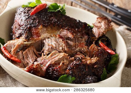 American Food Pernil Asado Shredded Pork Closeup On A Plate On The Table. Horizontal