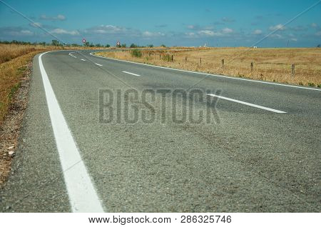 Straight Road Through Rural Landscape Near The Monfrague National Park
