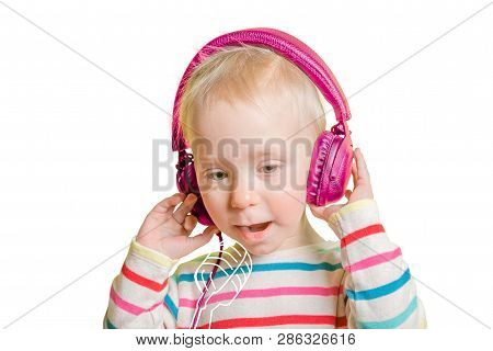 Young Toddler Girl Listening To Headphones And Singing To Imaginery Mic. Talent Show Concept