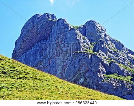Mountain Hikers On The Alpine Peak Of Margelchopf And In The Alviergruppe Mountain Range - Canton Of