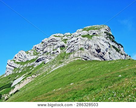 Mountain Hikers On The Alpine Peak Of Margelchopf And In The Alviergruppe Mountain Range - Canton Of