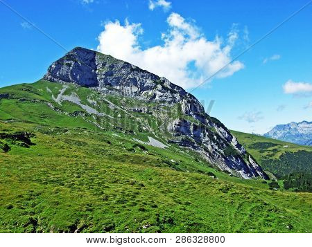 Mountain Hikers On The Alpine Peak Of Margelchopf And In The Alviergruppe Mountain Range - Canton Of