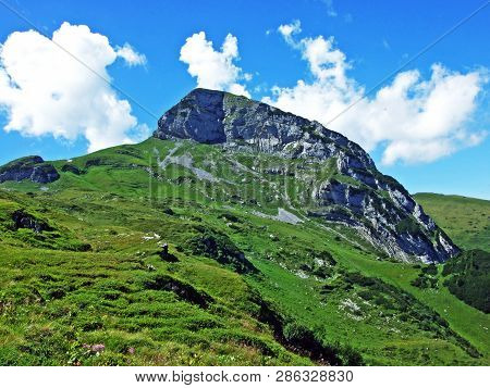 Mountain Hikers On The Alpine Peak Of Margelchopf And In The Alviergruppe Mountain Range - Canton Of