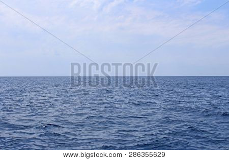 Seascape With Sea Horizon And Almost Clear Deep Blue Sky. Background