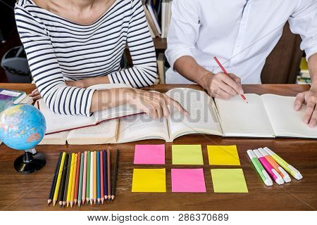 Education, Teaching, Learning Concept. Two High School Students Or Classmates Group Sitting In Libra