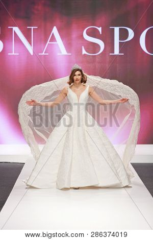 ZAGREB, CROATIA - FEBRUARY 02, 2019: Fashion model in a wedding dressby Vesna Sposa  walking down the runway at the Wedding fair
