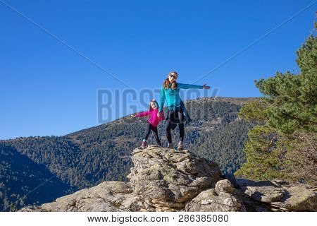 Mountaineer Happy Family (woman And Five Years Old Girl) Posing On The Top Of Rock In Mountain Of Fu