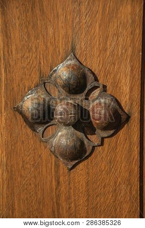 Close-up Of Wrought Iron Stud In Flower Shape On An Old Wooden Door At Sundown In Trujillo. A Small 