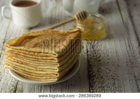 Pancakes. Thin Pancakes. Russian Bliny. Healthy Tasty Breakfast - Pancakes, A Cup Of Tea And Honey. 