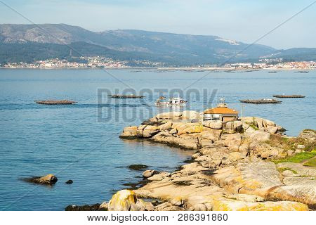 Rias Baixas Seascape With Punta Cabalo Lighthouse And Mussel Boat