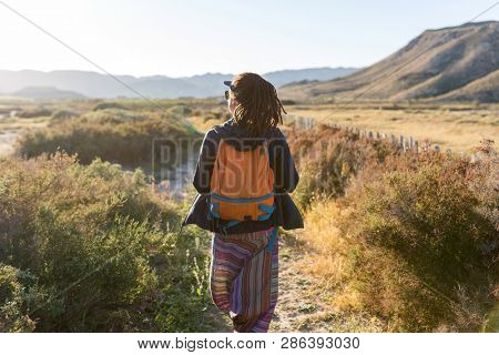 Rear view of a woman admiring Spanish landscape, Rambla del Playazo, Cabo de Gata - Nijar Natural Park, Spain