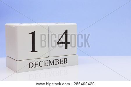 December 14st. Day 14 Of Month, Daily Calendar On White Table With Reflection, With Light Blue Backg