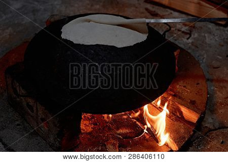 Pita Bread Baking On A Saj Or Tava On Fire, Close-up