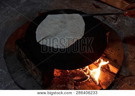 Pita Bread Baking On A Saj Or Tava On Fire, Close-up