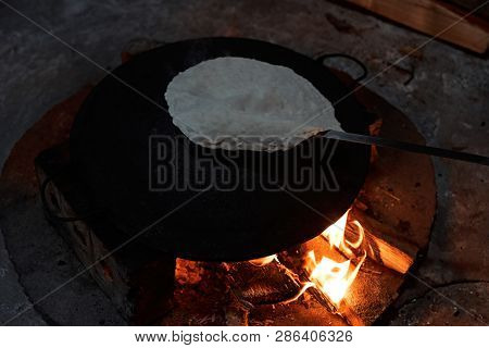 Pita Bread Baking On A Saj Or Tava On Fire, Close-up