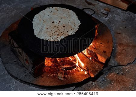 Pita Bread Baking On A Saj Or Tava On Fire, Close-up