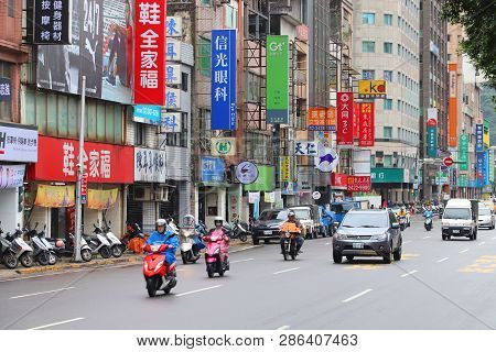 Keelung, Taiwan - November 23, 2018: People Ride Scooters In Keelung, Taiwan. Keelung Is The 9th Mos