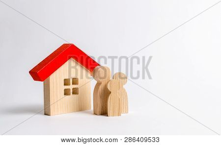 Figures Of The Family And House On A White Background. Real Estate, Your Own Home. Buying Or Selling