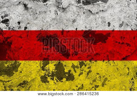 South Ossetia Flag On Old Wall. Patriotic Grunge Background. National Flag Of South Ossetia