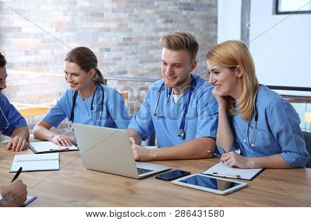 Medical Students In Uniforms Studying At University