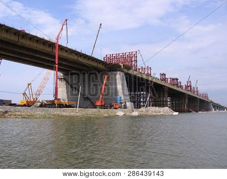 Construction Bugrinskij Bridge In Novosibirsk On The River Ob A Pile Of Large Stones For Building Co
