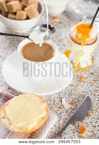 Cup Of Tea Or Coffee With Milk, Bread With Butter, The Soft-boiled Egg In An Eggcup And Brown Sugar.