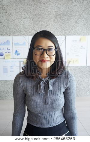 Portait Of Asian Pretty Office Worker In Eyeglasses Standing At Office During Business Presentation